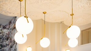 A ceiling with ornate floral patterns and three pendant lights with spherical bulbs. - Splendid Hotel Lac d'Annecy - Handwritten Collection (Annecy)