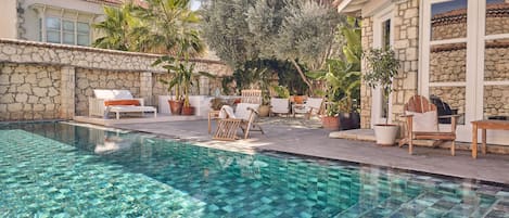 Outdoor pool, open 9:00 AM to 9:00 PM, pool umbrellas, pool loungers