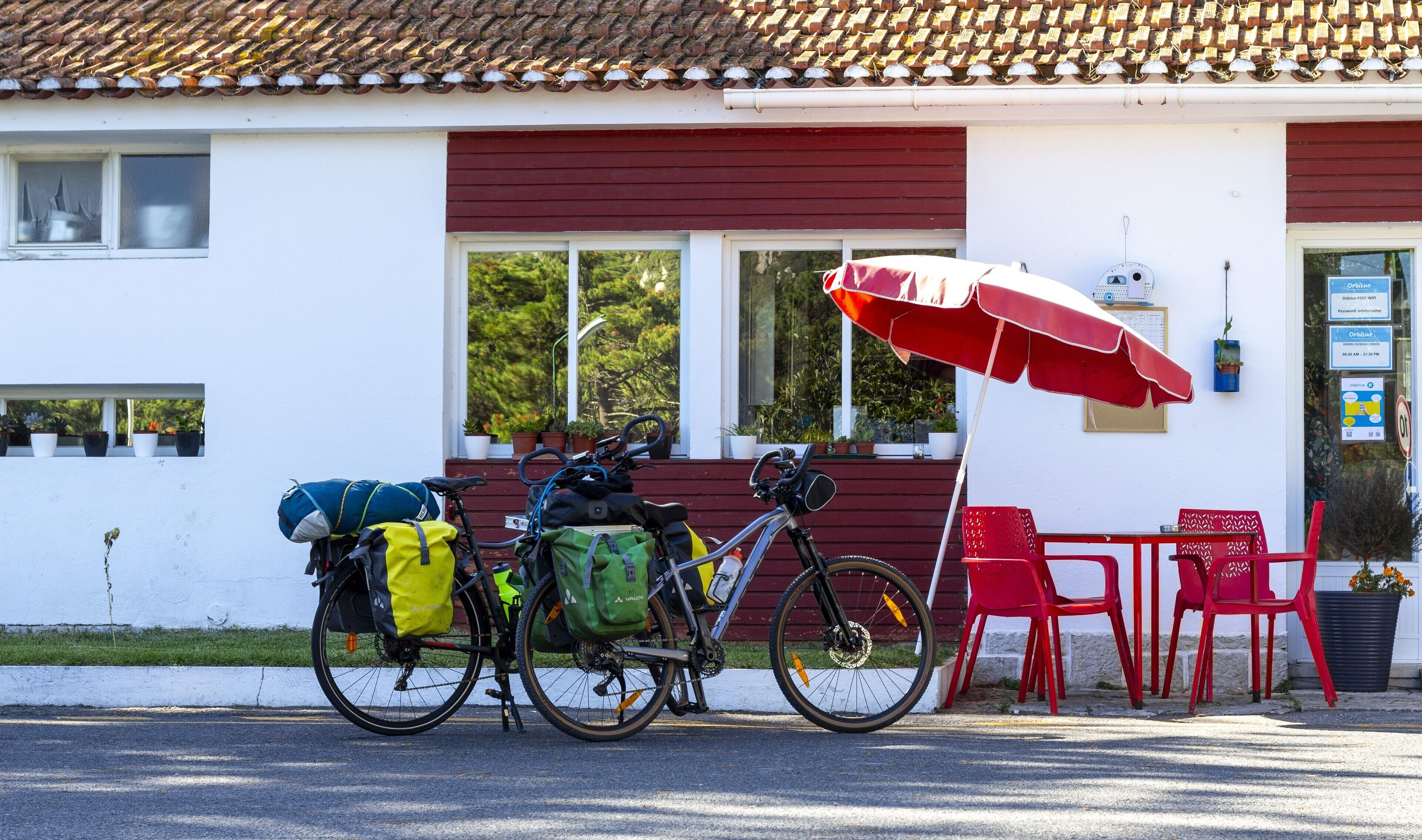 A building with a red awning and a bicycle parked outside.