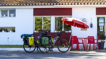 A building with a red awning and a bicycle parked outside.