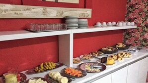 A buffet with various food items and utensils.