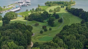 An aerial view of a golf course with a marina and a clubhouse. - Barren River Lake State Resort Park (Lucas)