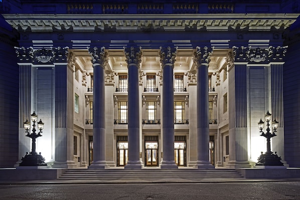 A grand building with large columns, a central entrance, and a symmetrical facade.