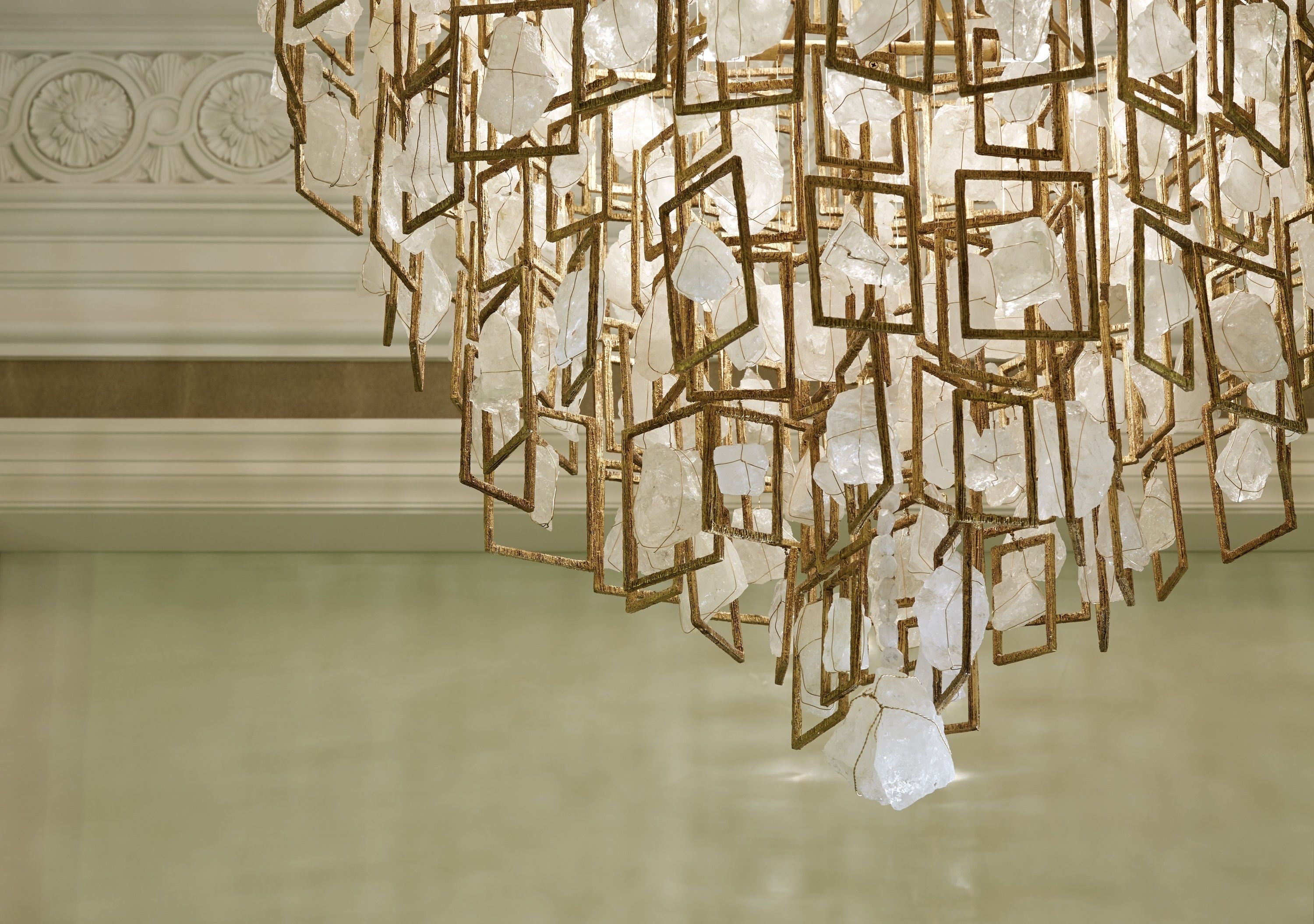 A chandelier with a geometric design and clear glass elements.