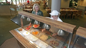 A buffet area with various food options and a seating area in the background. - Rough River Dam State Resort Park (Falls of Rough)