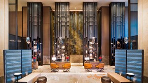 A modern lobby with a central seating area, decorative panels, and a patterned wall. - Meixi Lake Hotel, A Luxury Collection Hotel, Changsha (Changsha)