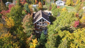 A multi-story house surrounded by autumn foliage. - Warbler's Roost Country Inn B&B (Unorganized Centre Parry Sound)