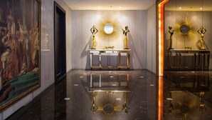 A luxurious lobby with marble floors, a large mirror with a sunburst design, and a statue on a pedestal. - All-Ur Boutique Motel KaoHsiung Branch (Kaohsiung)