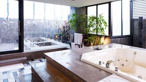A modern bathroom with a large bathtub, a glass-enclosed shower area, and a view of a garden. - All-Ur Boutique Motel KaoHsiung Branch (Kaohsiung)