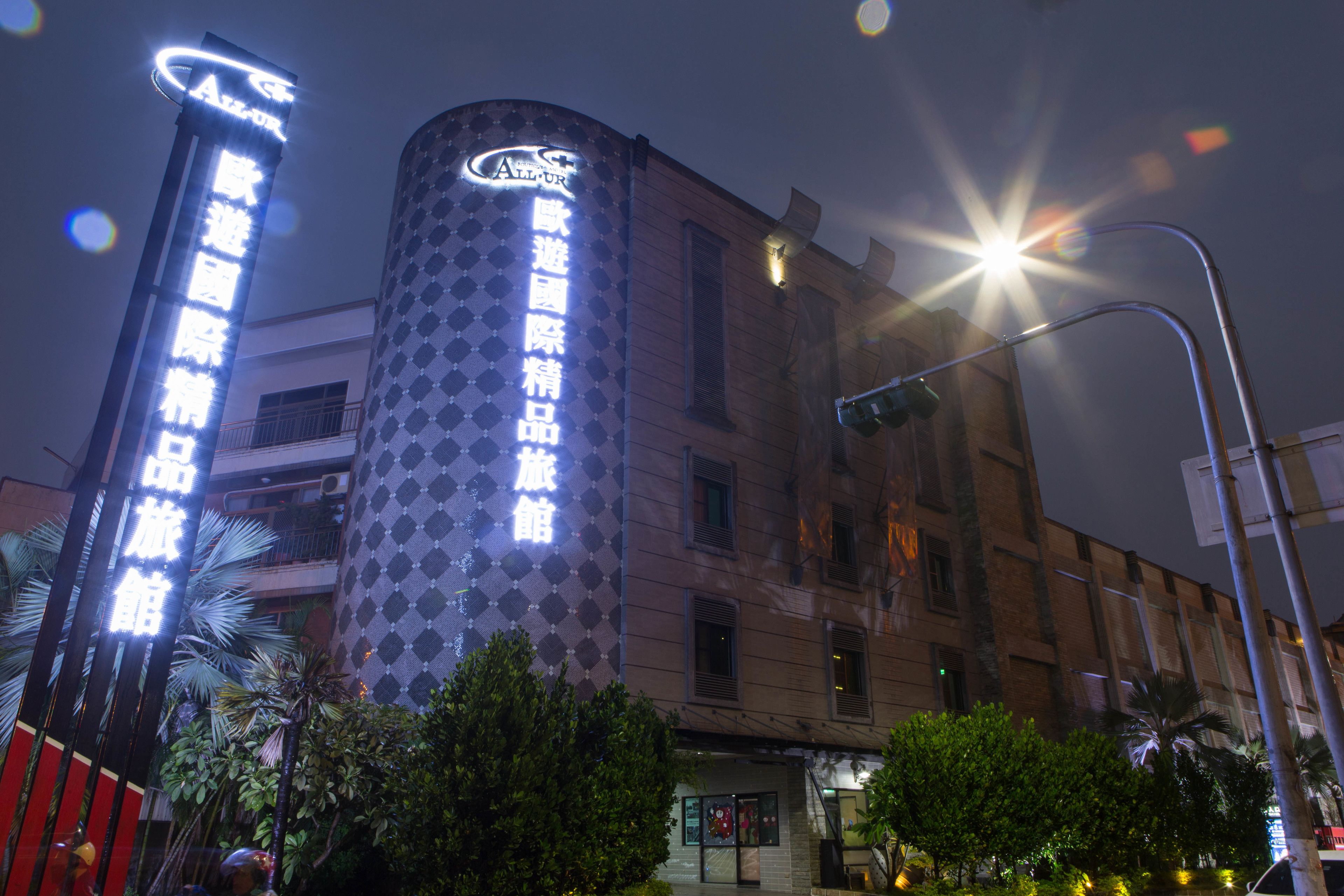 A hotel with a distinctive cylindrical facade and illuminated signage.