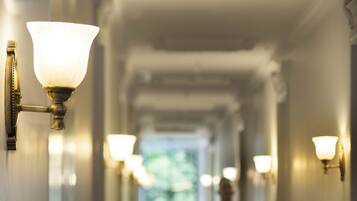 A hotel corridor with a person walking away from the camera.