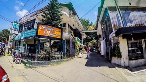 A hotel named 'Hotel Sunrich' with a signboard, a balcony, and a view of the street. - Hotel Sunrich Kandy (Hedeniya)