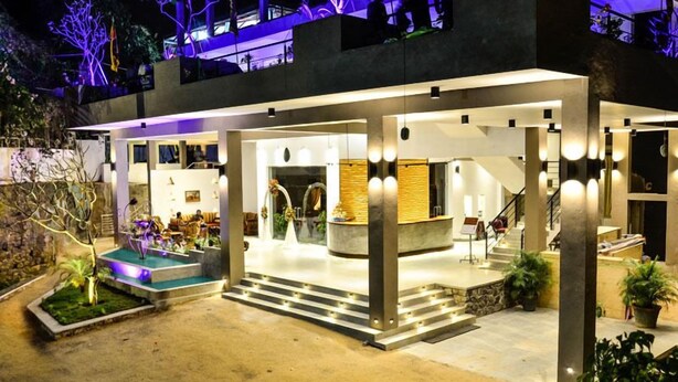 A modern hotel with a spacious lobby, a reception area, and a staircase leading to upper floors. - Hotel Sunrich Kandy (Hedeniya)