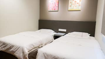 A twin room with two single beds, a small bedside table, and a nightstand.