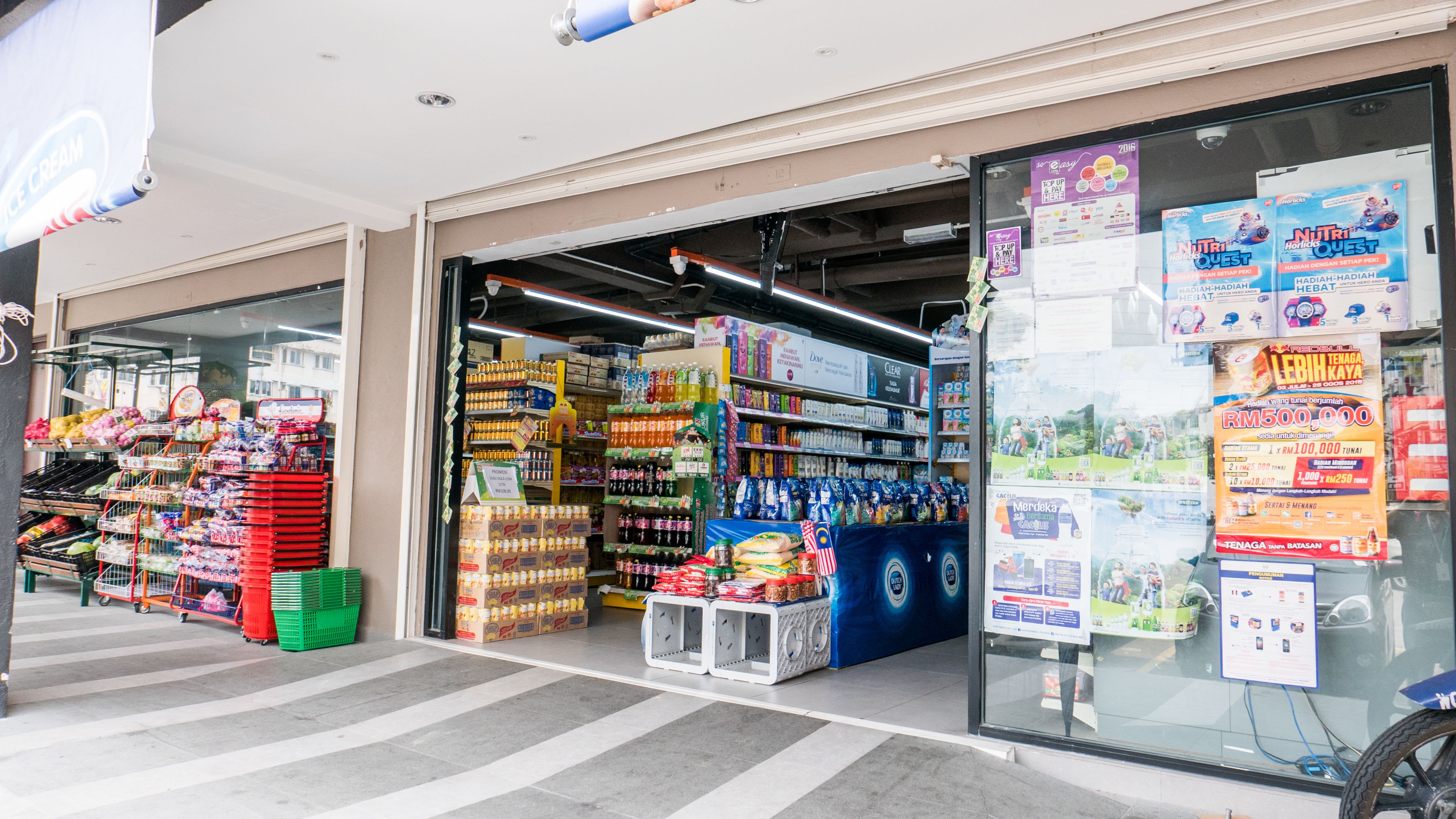 A grocery store with shelves stocked with various products, including beverages and snacks.
