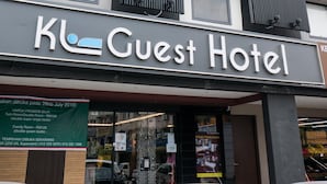 A building with a sign reading "Kl Guest Hotel".