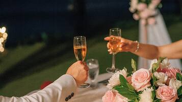 A table set for a meal with a floral centerpiece, a glass of water, and a glass of wine.
