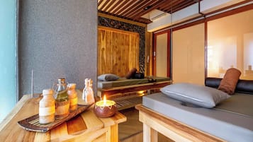 Relax in a serene spa room with a comfortable seating area and a space for rest.