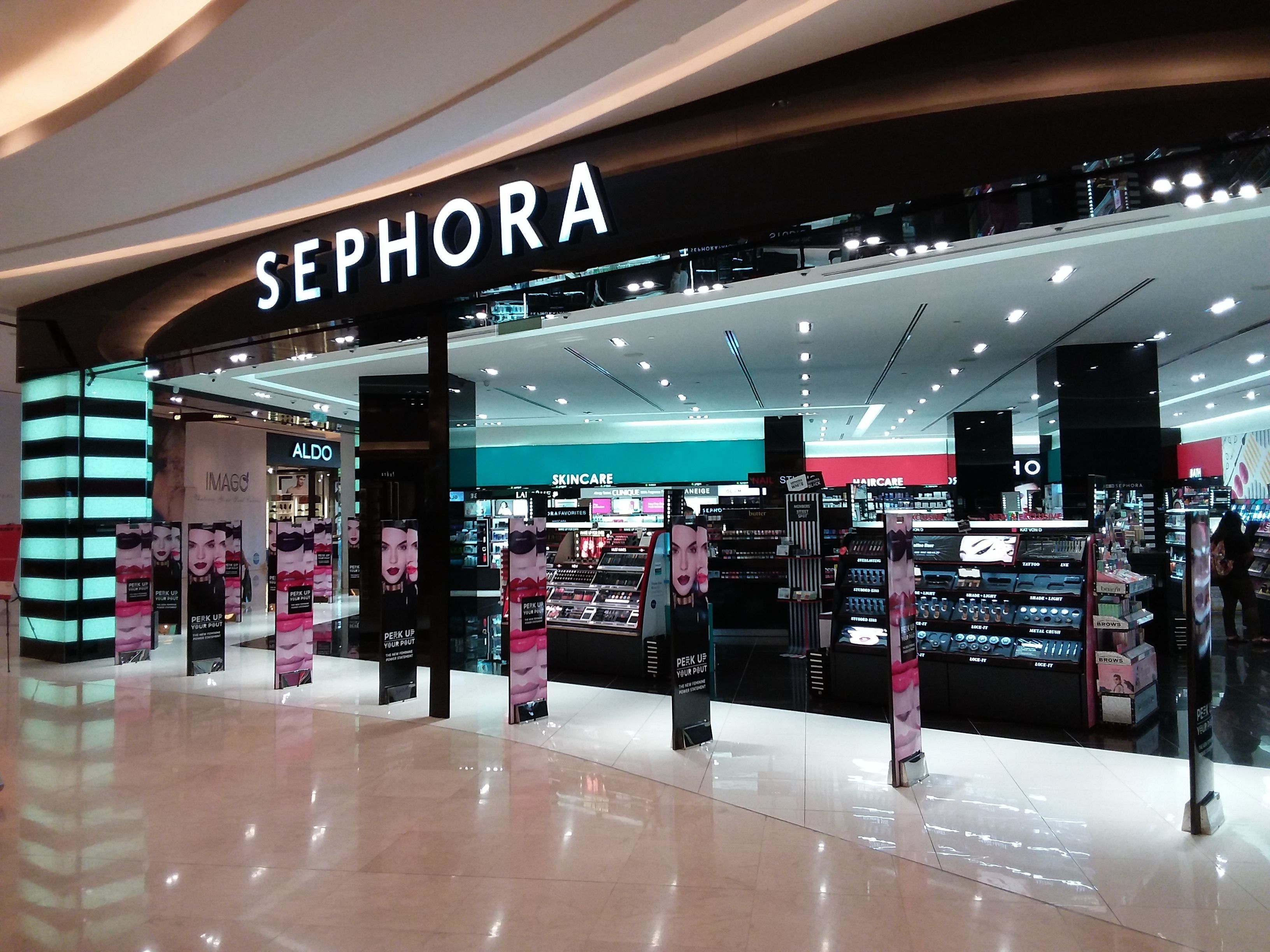 A Sephora store with a modern interior, featuring well-lit display areas and a variety of cosmetic products.