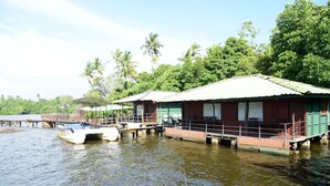 Floating houses with a waterway in between, surrounded by greenery and palm trees. - Shiny Lakeside Resort (Hikkaduwa)