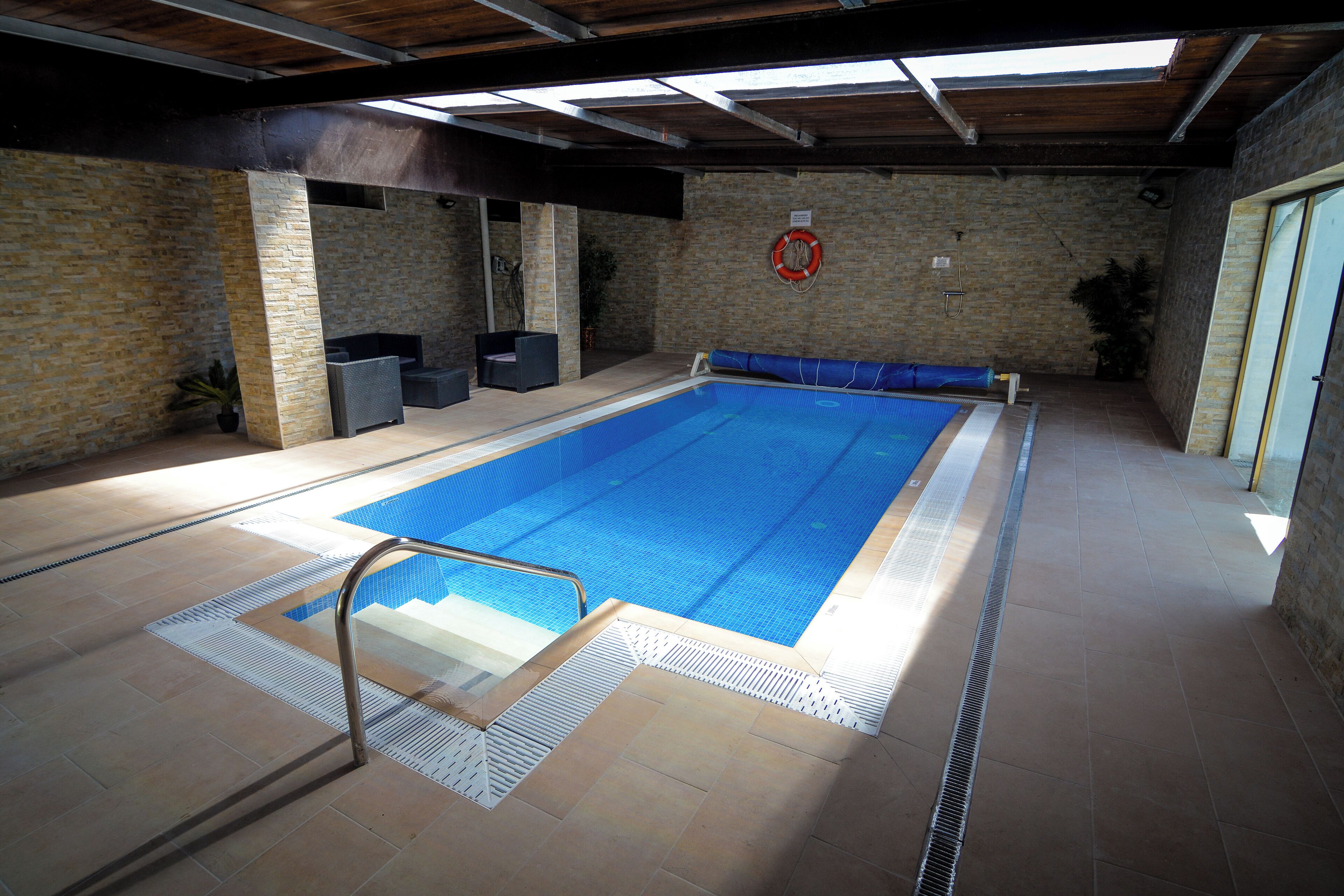 indoor pool, pool umbrellas, pool loungers