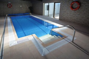 Indoor pool, pool umbrellas, pool loungers