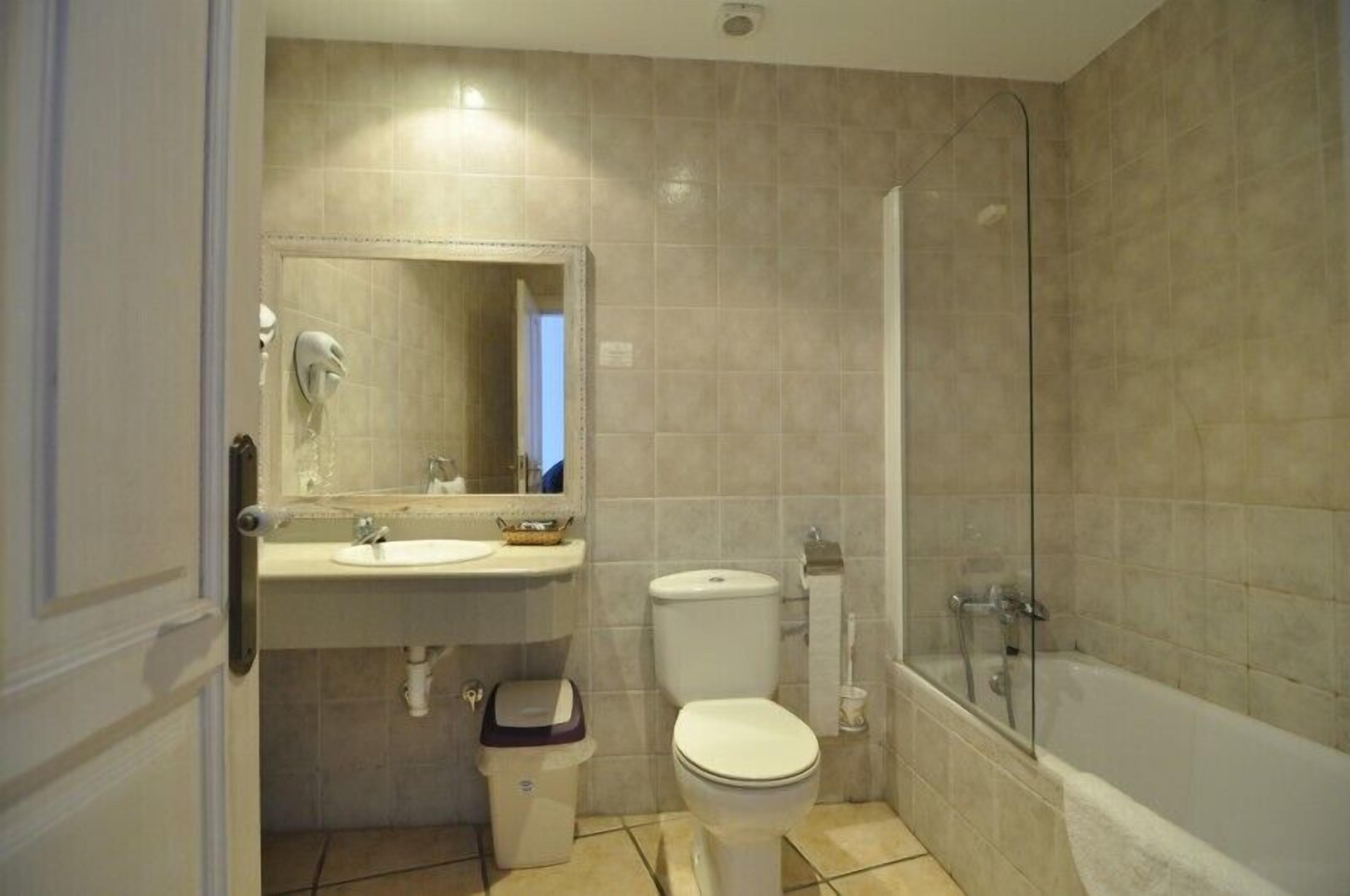 A bathroom with a sink, toilet, and bathtub.