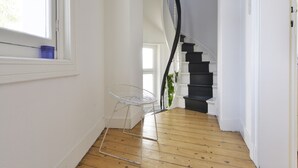A staircase with a black railing leading to a landing. - Zurenborg Area Apartments (Antwerp)