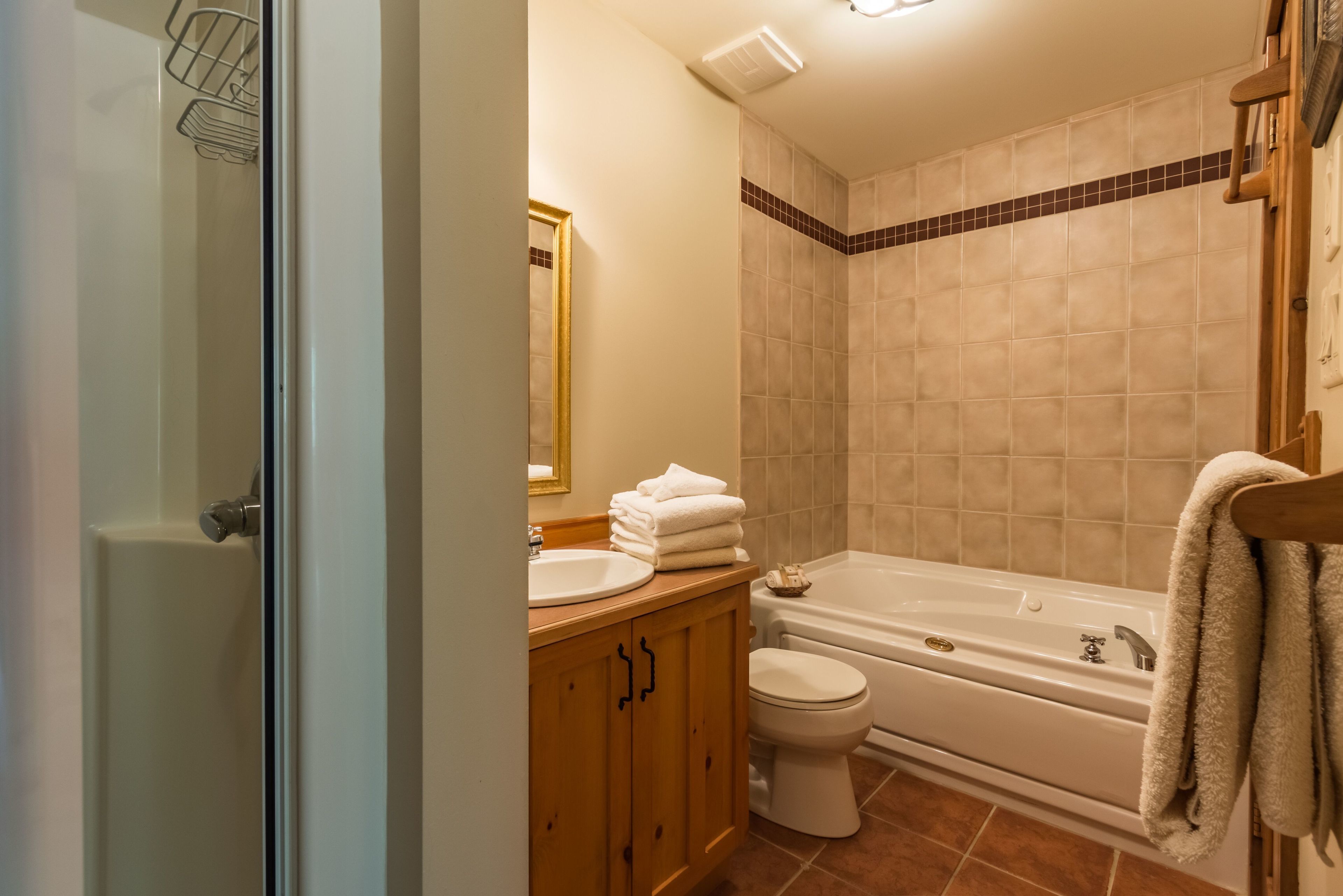 A bathroom with a toilet, sink, and bathtub.