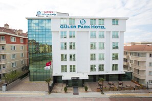 A modern hotel building with a glass facade, multiple balconies, and a sign indicating it is the Güler Park Hotel. - Guler Park Hotel (Bursa)