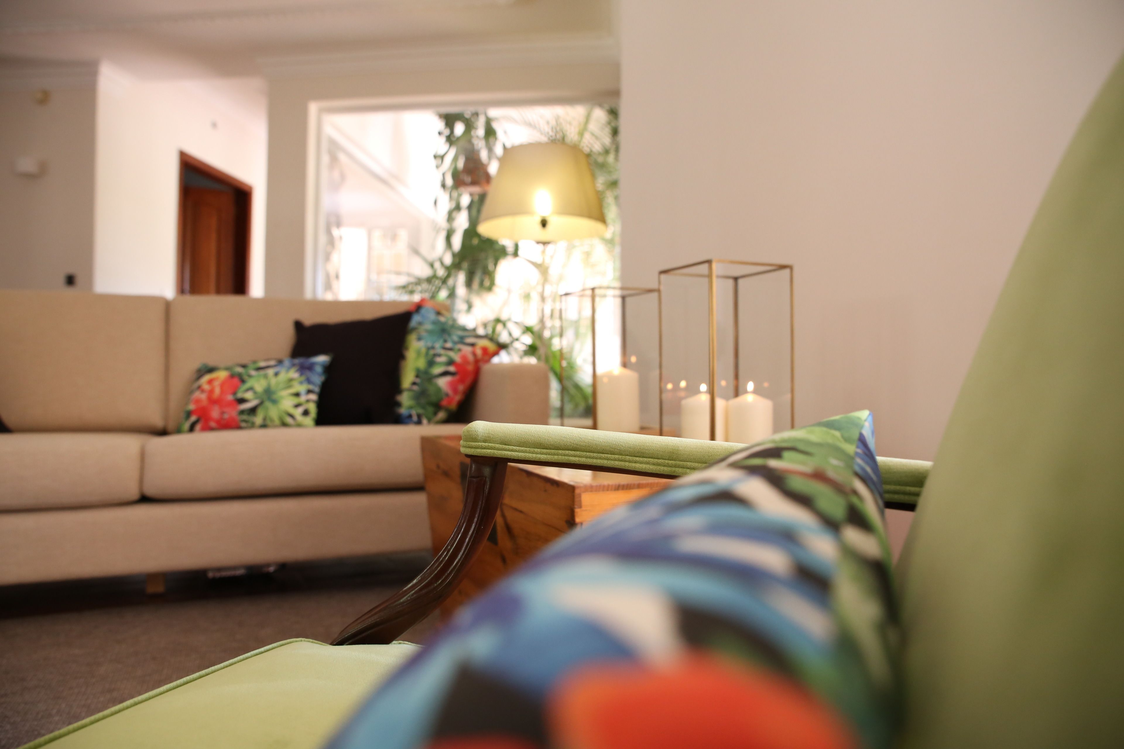 A living room with a sofa, a lamp, and a side table.
