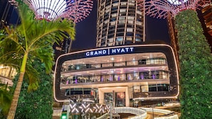 A Grand Hyatt hotel with a modern design, surrounded by tall buildings and illuminated by decorative lights. - Grand Hyatt Abu Dhabi Hotel & Residences (Abu Dhabi)