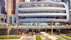 A Grand Hyatt hotel with a modern design, multiple floors, outdoor seating areas, and a pool. - Grand Hyatt Abu Dhabi Hotel & Residences (Abu Dhabi)