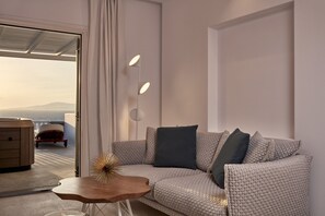 A modern living room with a sofa, a wooden coffee table, and a floor lamp.