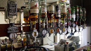 A bar with various liquor bottles and a whiskey tap. - Brooklands Over 50's Only (Blackpool)