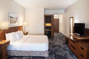 A hotel room with a large bed, bedside tables with lamps, a television, a microwave, and a wardrobe. - Fairfield Inn and Suites by Marriott Chillicothe (Chillicothe)