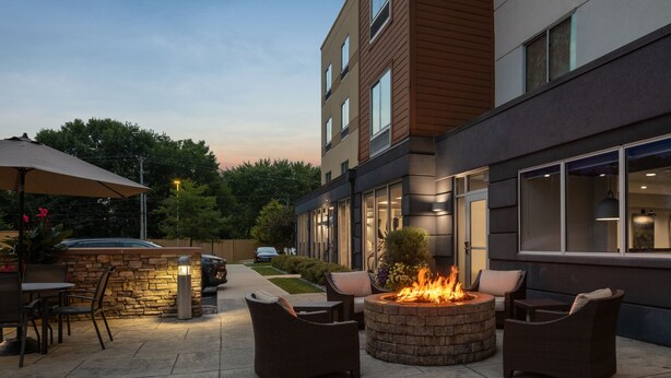 An outdoor patio area with a fire pit, seating, and a stone wall. - Fairfield Inn and Suites by Marriott Chillicothe (Chillicothe)