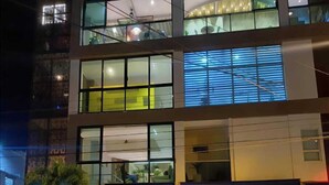 A multi-story building with large windows and a garage door. - Hotel Santa Clara Boutique (Montería)
