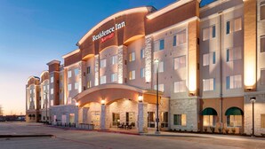 A multi-story hotel with a stone facade, a prominent entrance with a covered area, and a Marriott logo. - Residence Inn by Marriott Dallas Plano/Richardson (Plano)