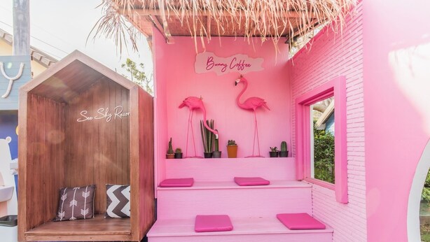 A pink building with a sign reading "Bunny Coffee" and two flamingos. There is a wooden structure labeled "See Sky Resort" to the left. - See Sky Resort (Pak Chong)