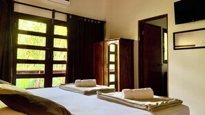 A hotel room with a bed, a wardrobe, and a door leading outside. - Hotel Villa Del Sol (Sardinal)