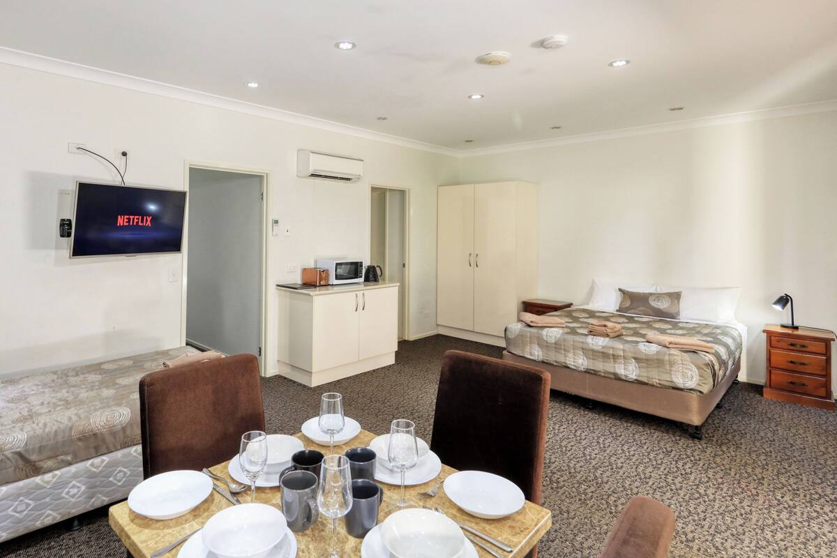 Family Room Down Stairs | Premium bedding, desk, soundproofing, iron/ironing board