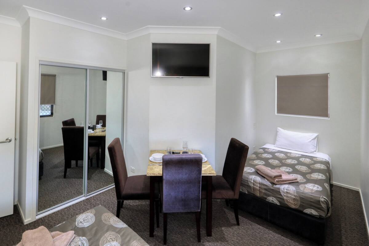 Family Room Upstairs | Premium bedding, desk, soundproofing, iron/ironing board