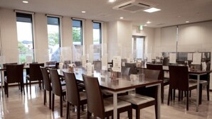 A conference room with a long table and chairs, large windows, and a view of the outdoors. - AZ Inn Handa Inter (Handa)