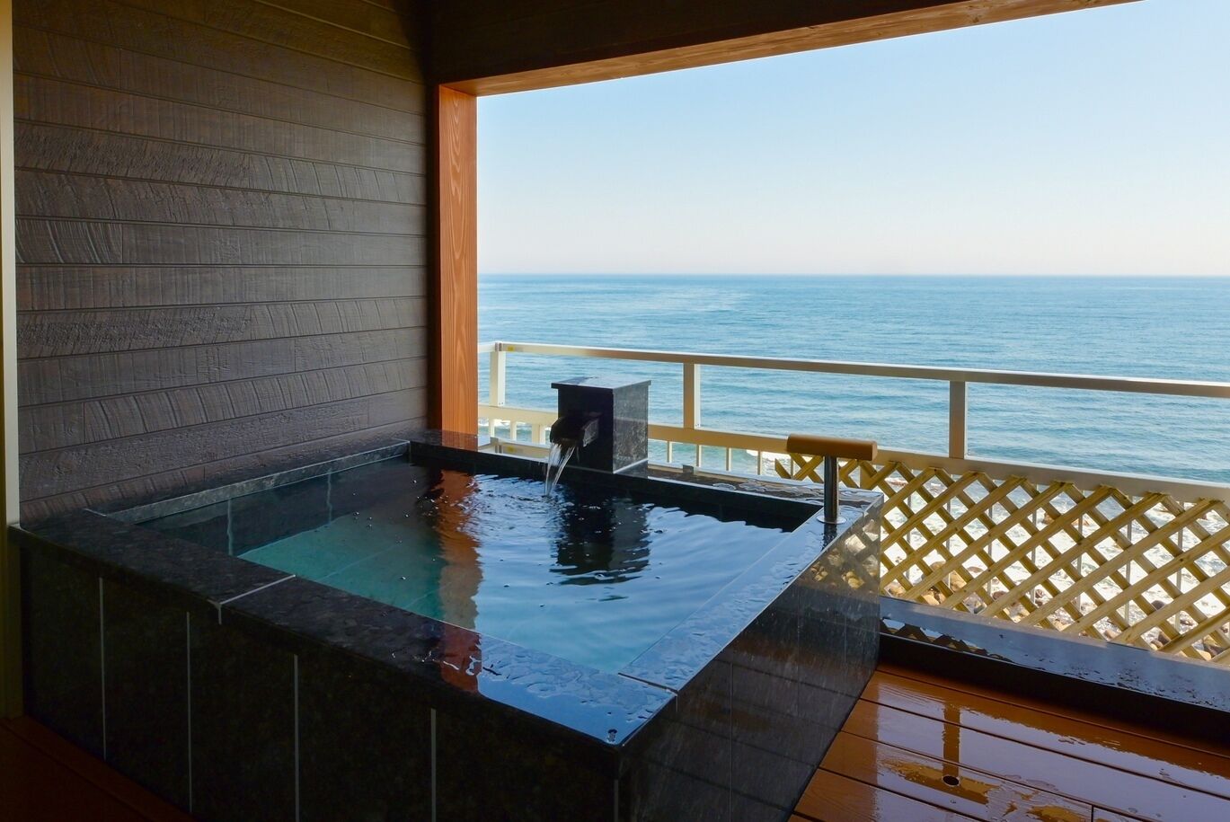A hot tub with a view of the ocean.