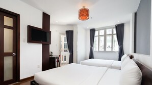 A hotel room with two beds, a TV mounted on the wall, and a window with curtains. -  A&A Toronto Hotel (Ho Chi Minh City)
