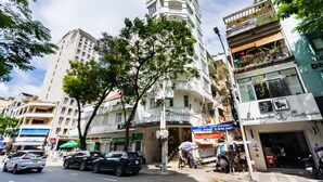 A hotel with a modern design, featuring a prominent entrance and multiple balconies. -  A&A Toronto Hotel (Ho Chi Minh City)