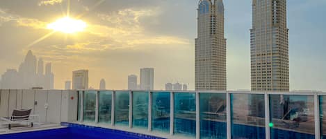 A rooftop pool with a city skyline in the background.