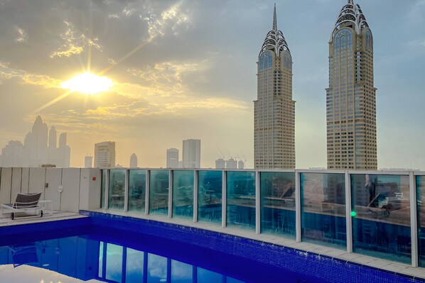 A rooftop pool with a city skyline in the background.
