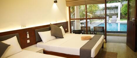 A hotel room with two beds, a large window with a view of a swimming pool, and a sliding glass door leading to an outdoor area.
